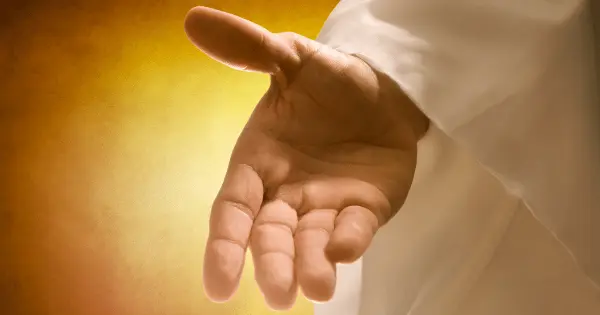 A close-up of a hand illuminated by light, symbolizing a Prayer to Thanking God for New Beginnings.