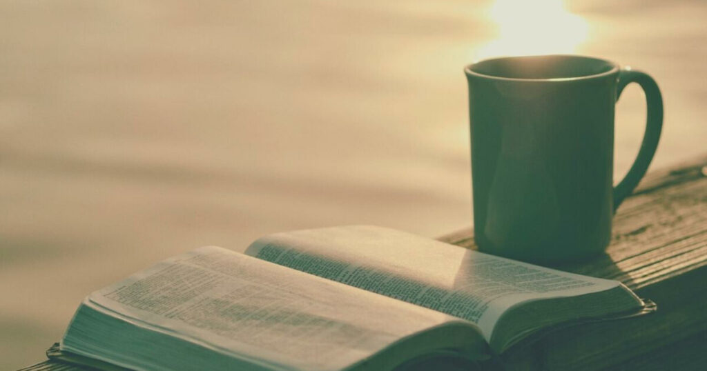 A serene dock scene featuring coffee and a Bible, embodying "A Monday Morning Prayer for Peace and Hope